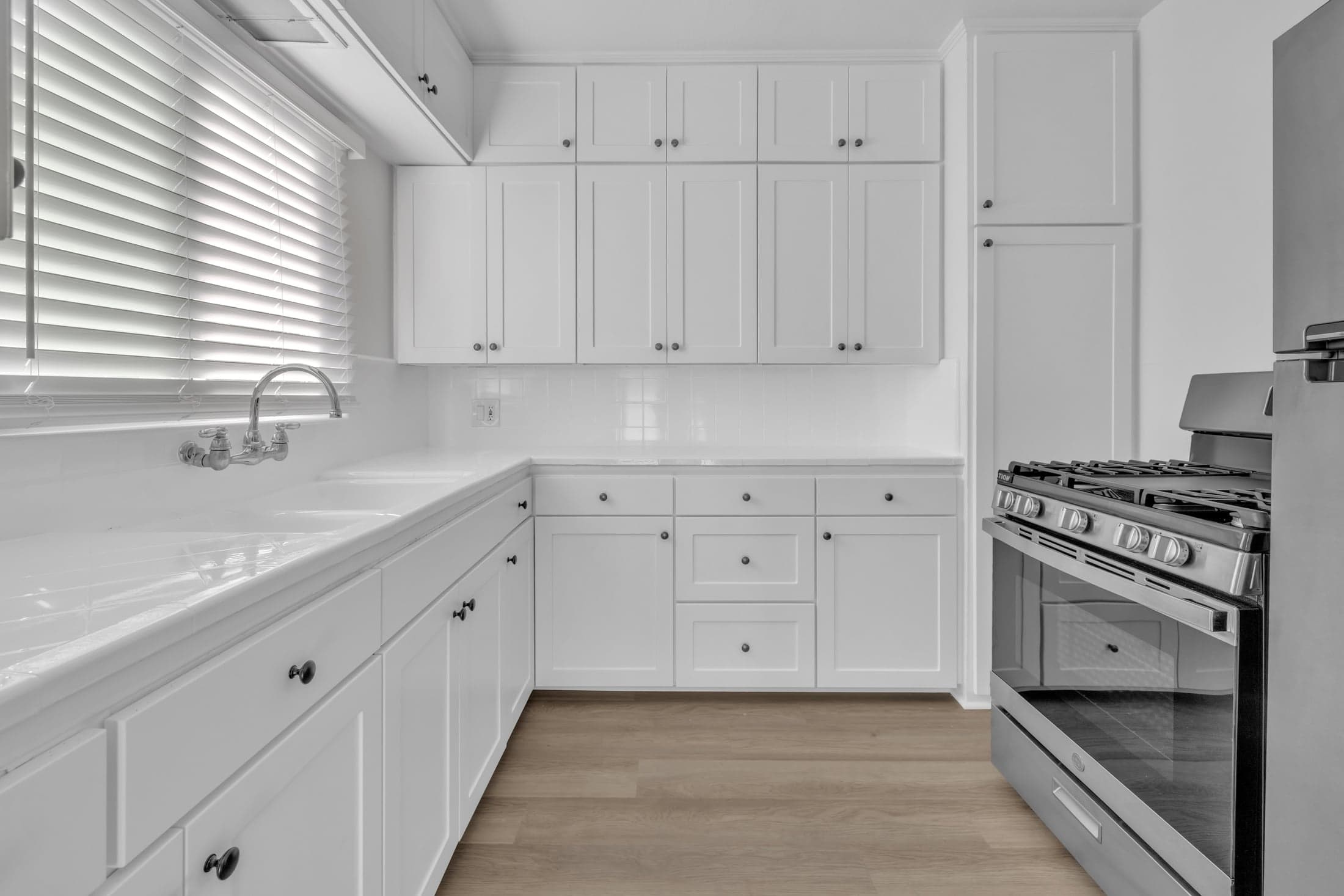 Palm Court apartment kitchen with white cabinets and stainless appliances