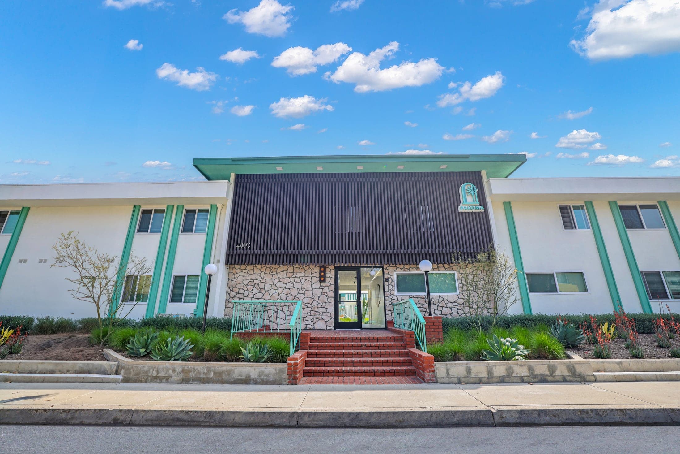 Paloma community facade with landscaped grounds and a central entrance