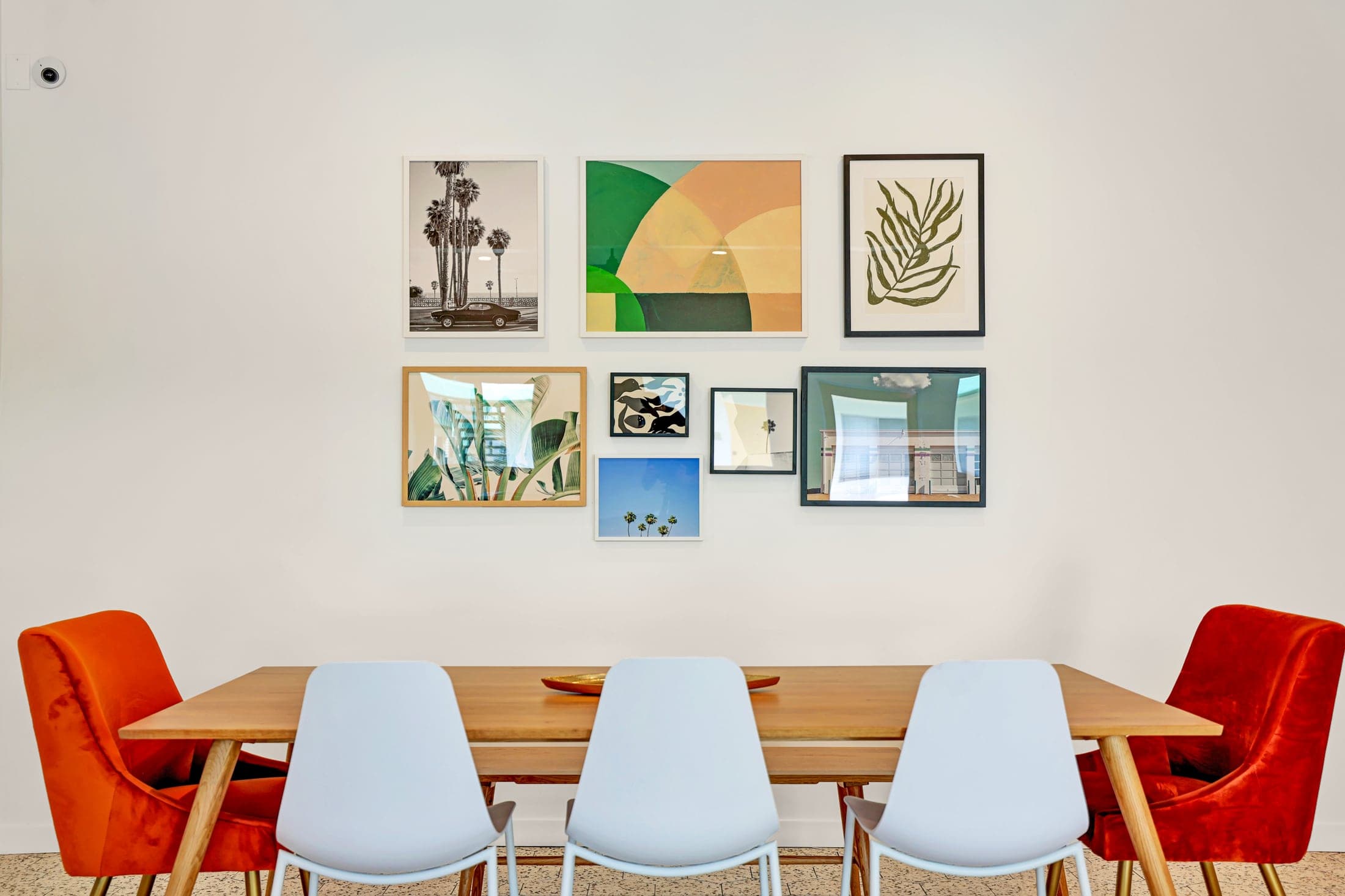 Paloma resident gathering space with colorful chairs and a gallery wall