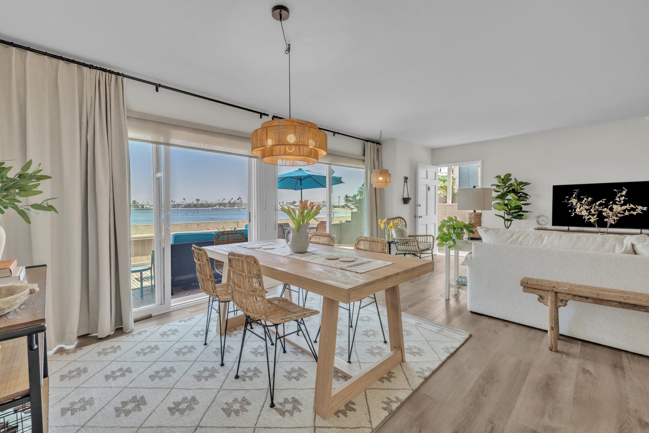 Bayshore vacation rental dining and living room with a waterfront view