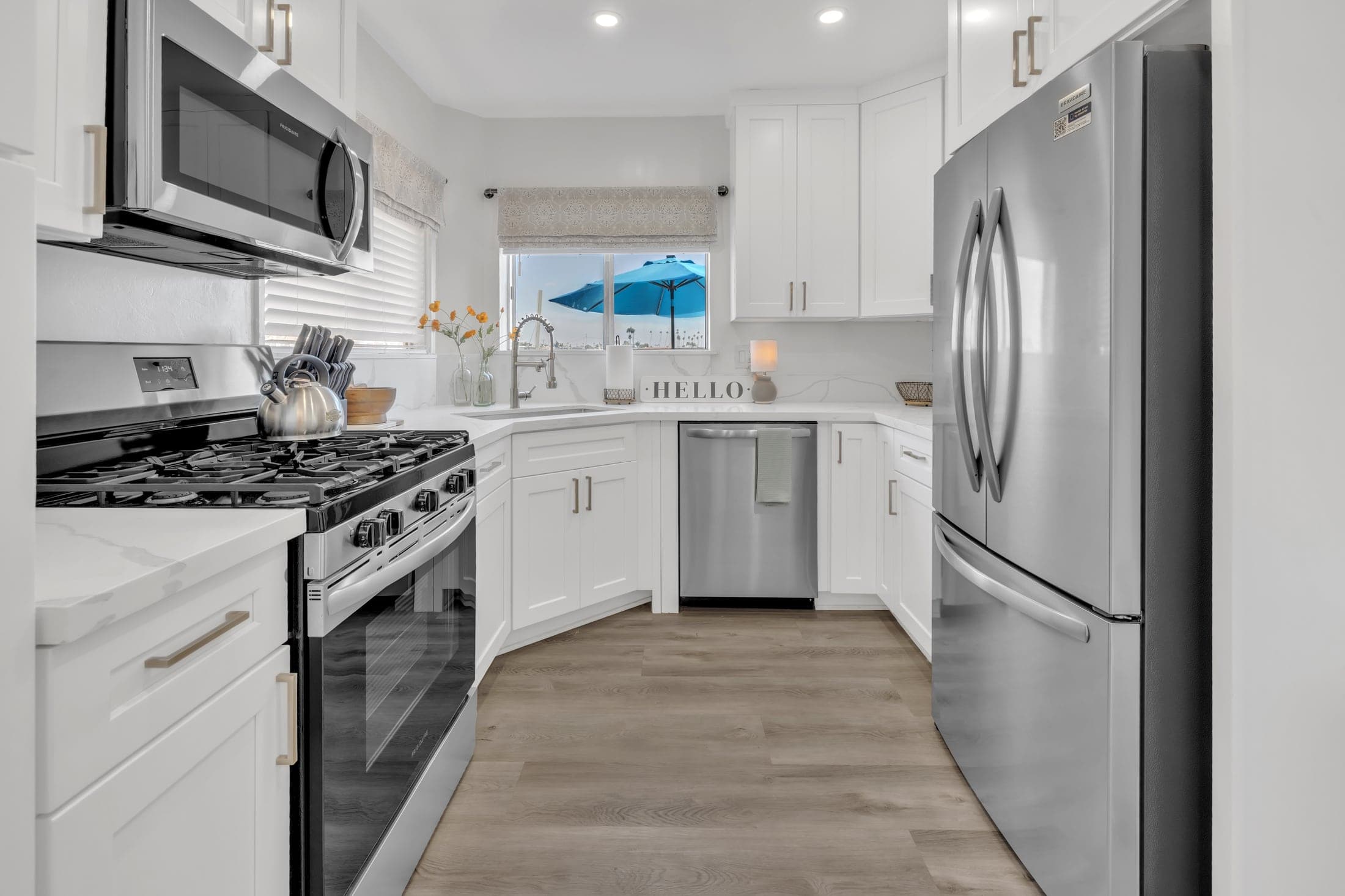 Bayshore vacation rental kitchen with white cabinetry and stainless appliances